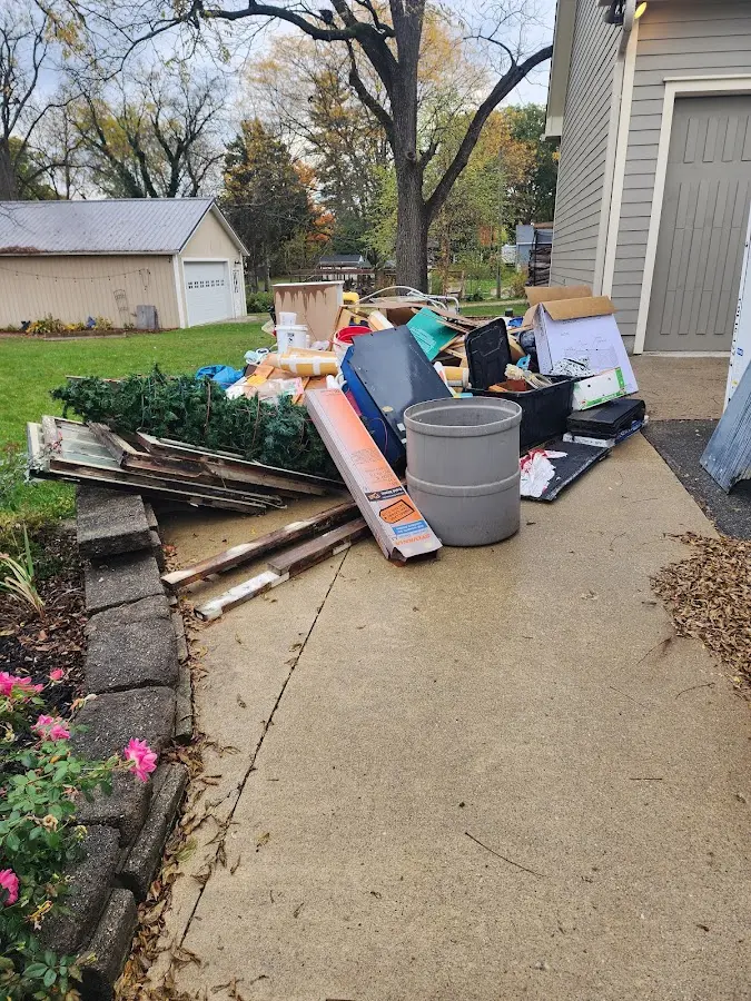 Dumpster being loaded with debris for Estate Cleanout Dumpster Rental in Silver Lakes